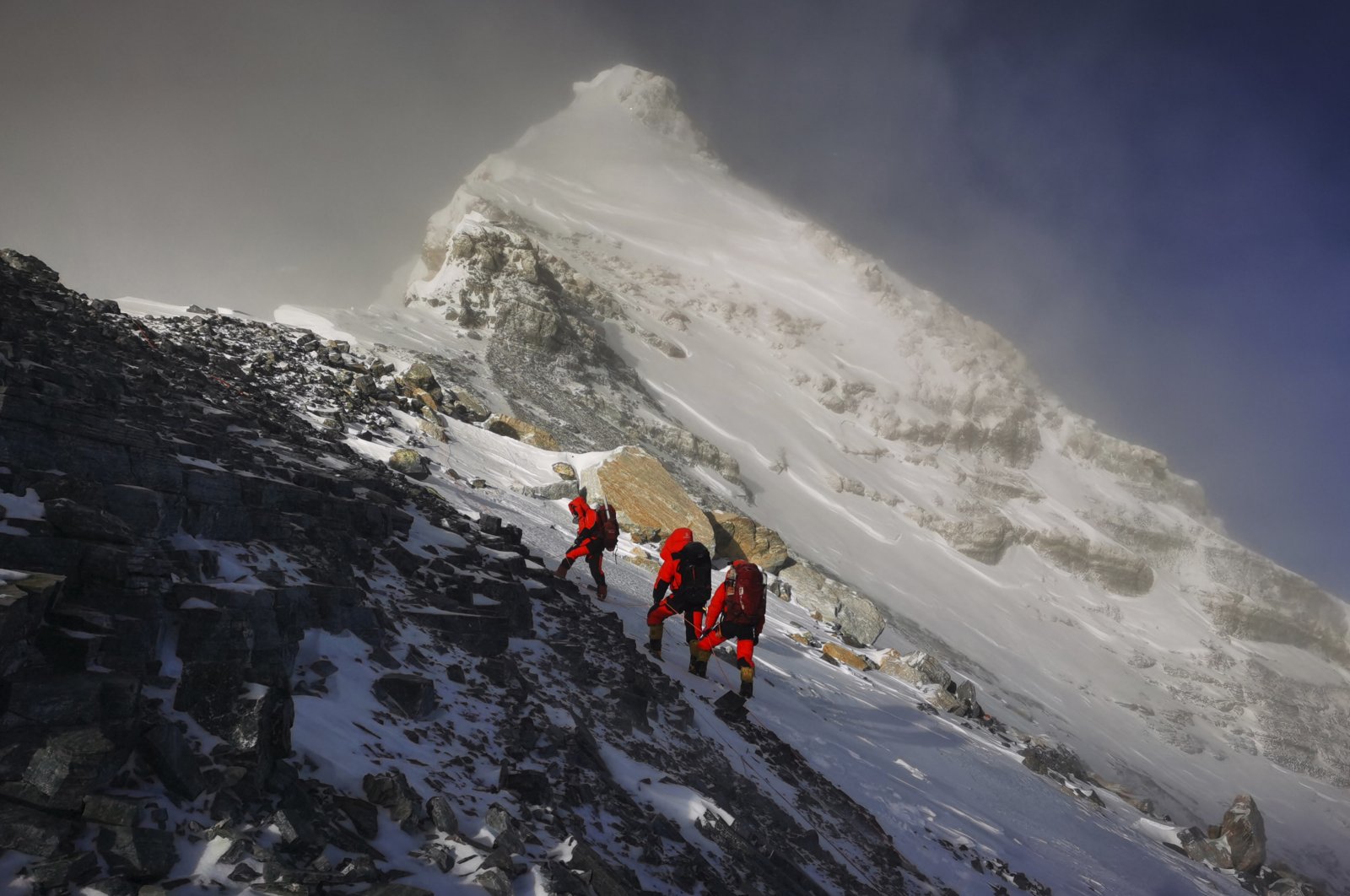 In this photo released by Xinhua News Agency, members of a Chinese surveying team head for the summit of Mount Everest, also known locally as Mt. Qomolangma, May 27, 2020. (AP Photo)