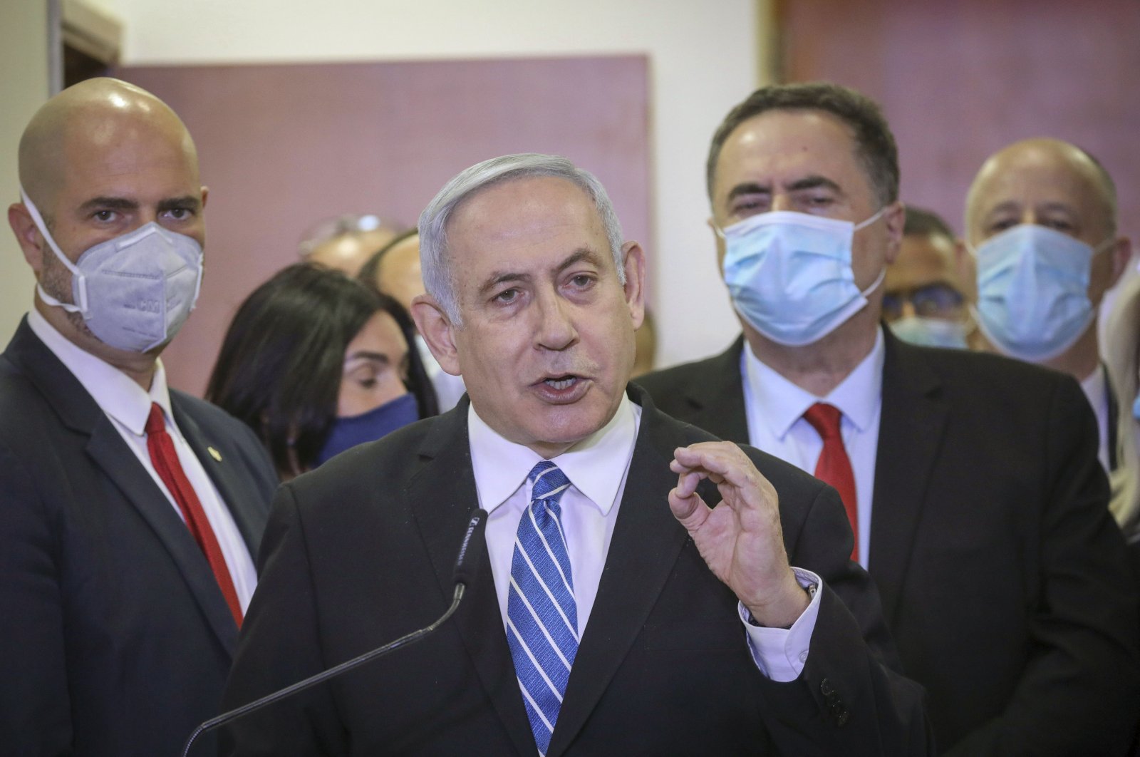 Israeli Prime Minister Benjamin Netanyahu accompanied by members of his Likud Party in masks delivers a statement before entering the district courthouse, Jerusalem, May 24, 2020. (AP Photo)