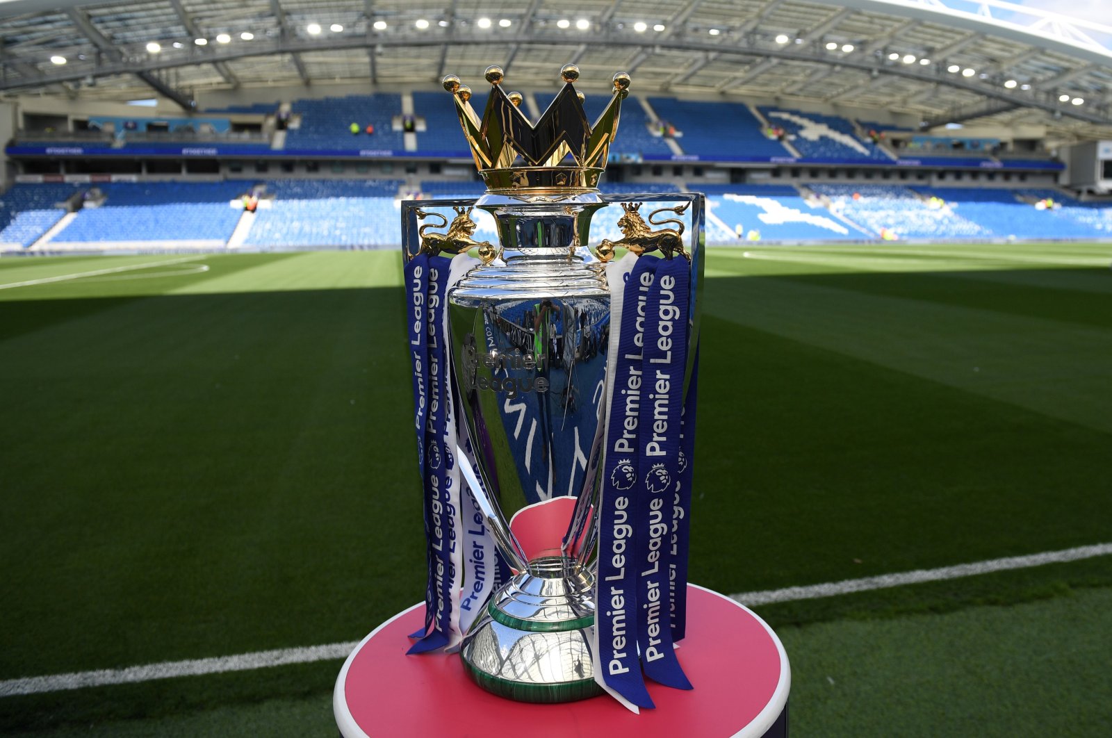 In this file photo taken on August 12, 2017, The Premier League trophy sits beside the pitch ahead of the English Premier League football match between Brighton and Hove Albion and Manchester City at the American Express Community Stadium in Brighton. (AFP Photo)