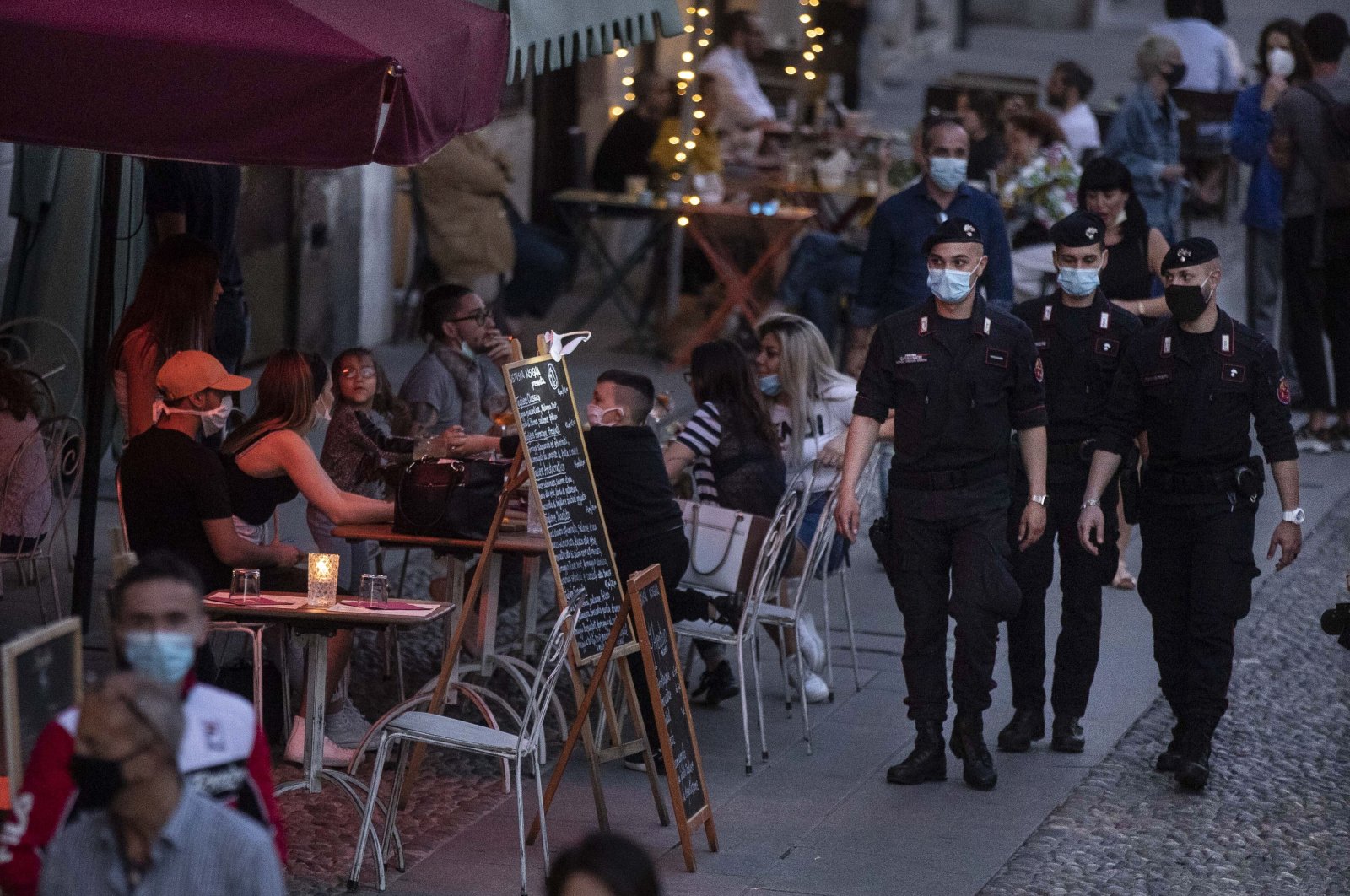 Carabinieri officers patrol the city trendy Navigli district in Milan, Italy, Tuesday, May 26, 2020. (AP Photo)