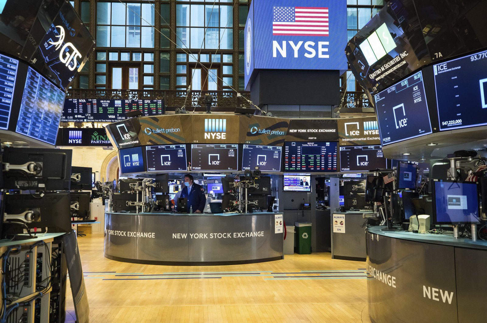 In this photo provided by the New York Stock Exchange, employees work on the partially reopened trading floor, Tuesday, May 26, 2020. (Courtney Crow/New York Stock Exchange via AP)