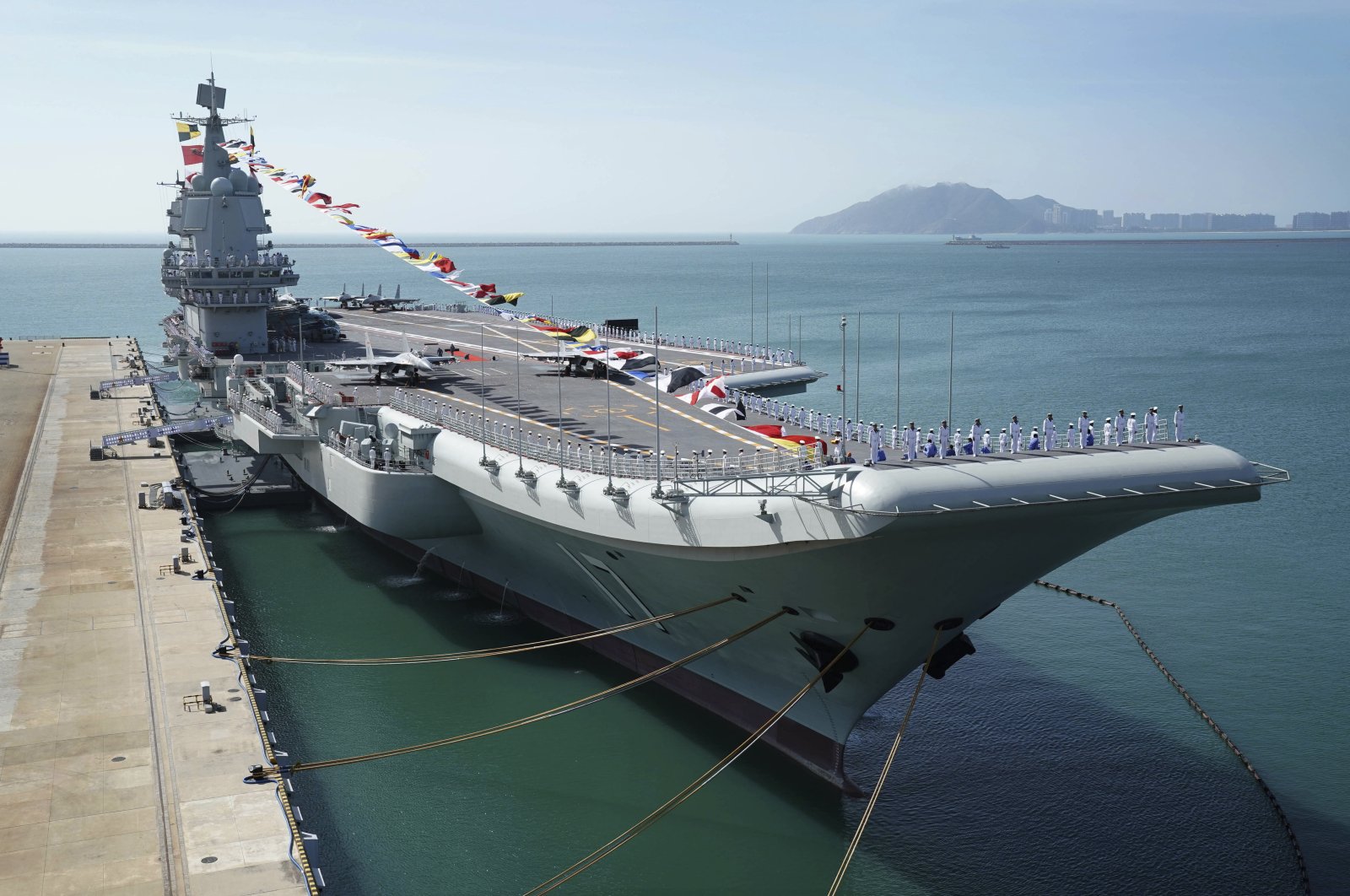 In this Dec. 17, 2019, file photo provided by Xinhua News Agency, the Shandong aircraft carrier is docked at a naval port in Sanya in southern China's Hainan Province. (Xinhua via AP)