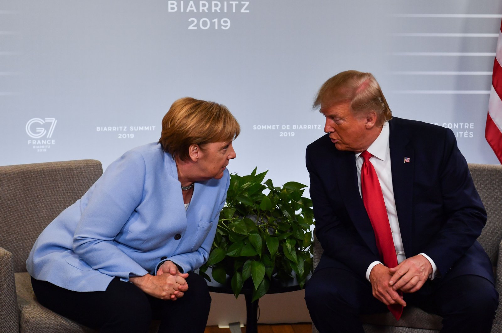 German Chancellor Angela Merkel (L) and U.S. President Donald Trump speak during a bilateral meeting on the sidelines of a Group of Seven summit in Biarritz, southwestern France, Aug. 26, 2019. (AFP Photo)