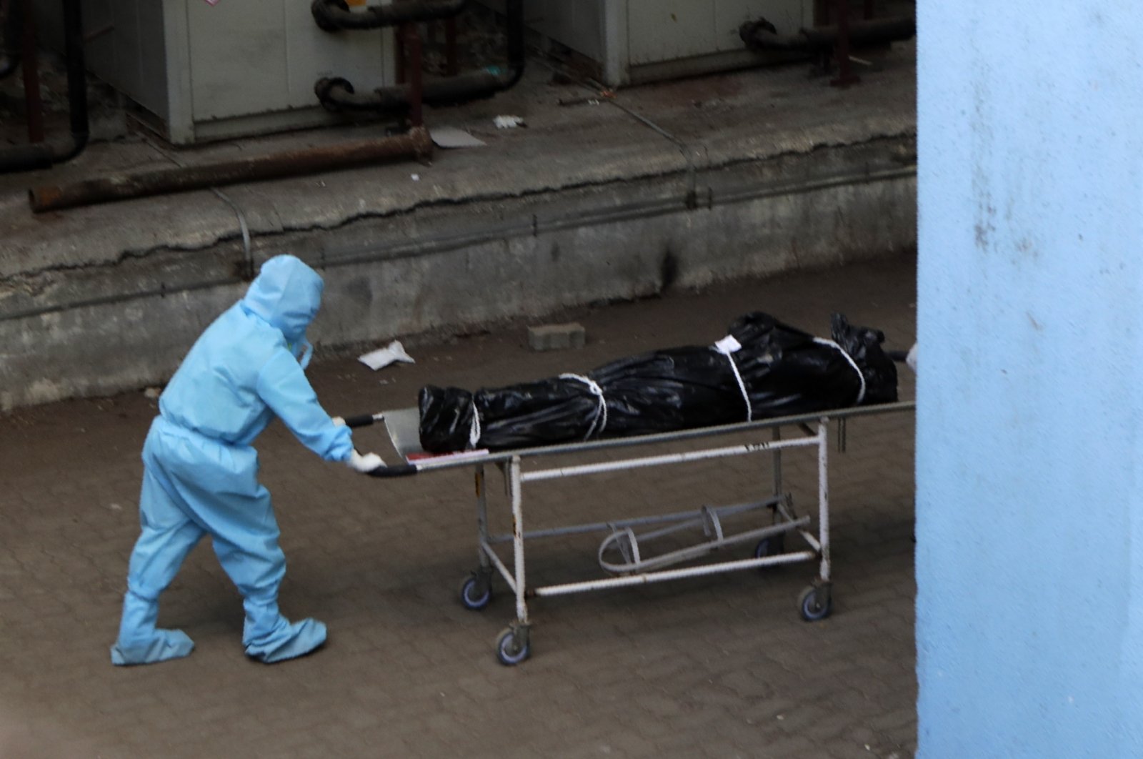 Hospital staff carries the body of a person who died of COVID-19 to a morgue in Mumbai, India, May 29, 2020. (AP Photo)
