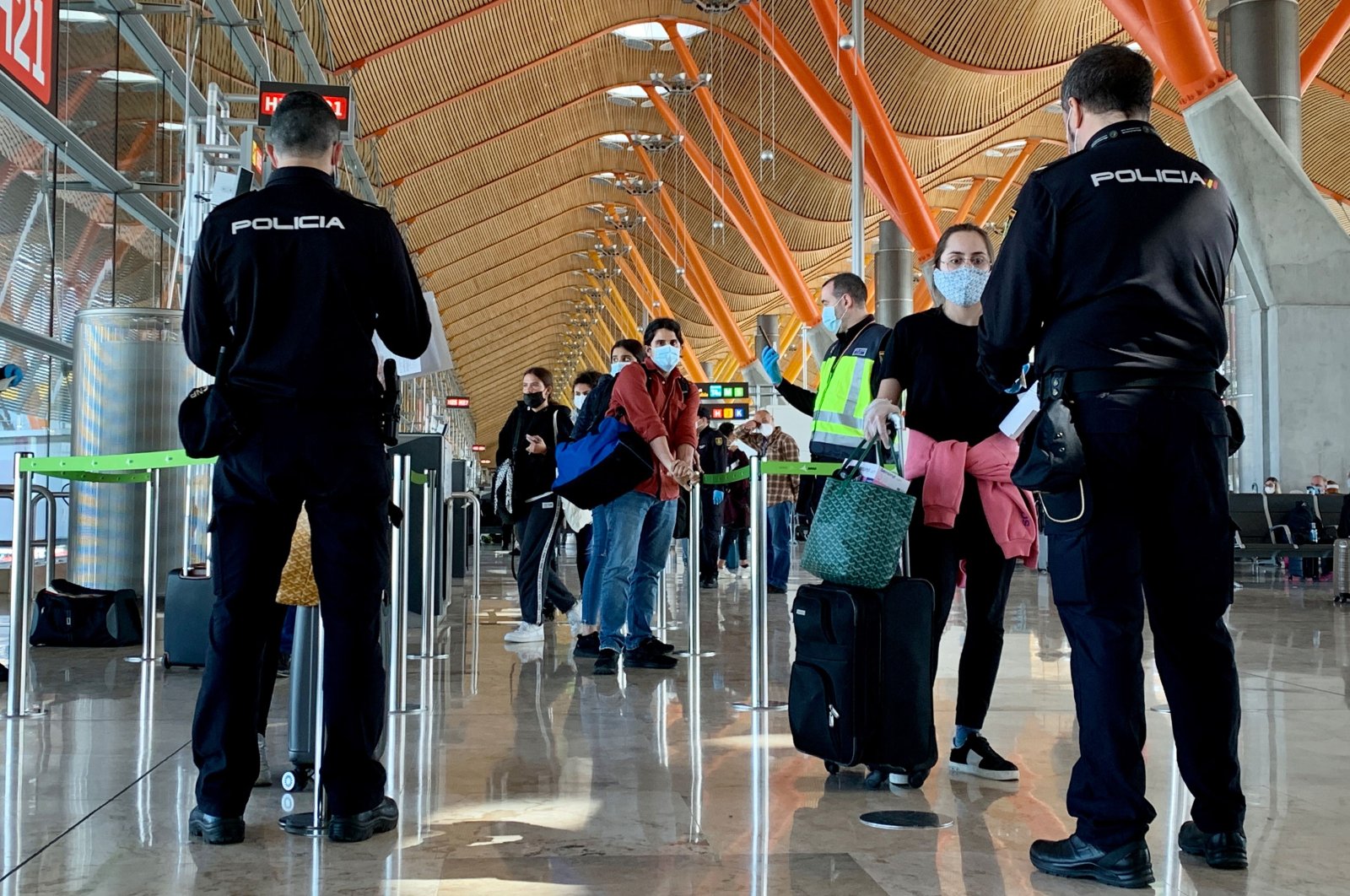 In this file photo taken on May 16, 2020 Spanish police officers check on passengers upon their arrival from Paris at the Madrid-Barajas Adolfo Suarez airport in Barajas. (AFP Photo)