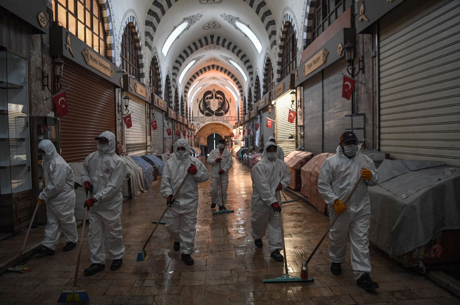 Fatih Municipality workers wearing personal protective equipment (PPE) disinfect the iconic Spice Bazaar to prevent the spread of the COVID-19, Istanbul, Turkey, May 28, 2020. (AFP Photo)