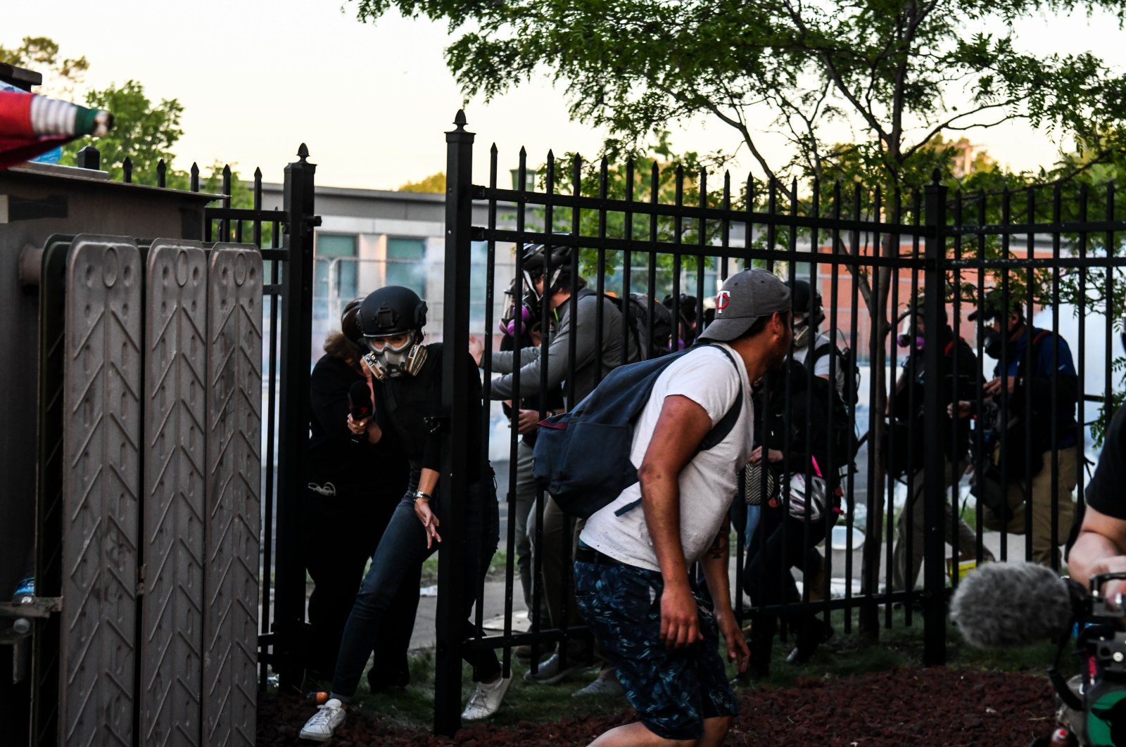 Protestors and media personnel run to take cover as police start firing tear gas and rubber bullets near the 5th police precinct following a demonstration to call for justice for George Floyd, in Minneapolis, Minnesota, U.S., May 30, 2020. (AFP Photo)