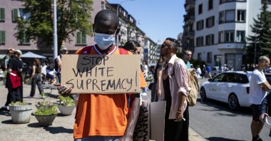 An activist wearing a face mask holds up a placard reading in English, "Stop White Supremacy!" as he takes part in a Black Lives Matter protest against the recent death of George Floyd, in Zurich, Switzerland, June 1, 2020. (EPA Photo)