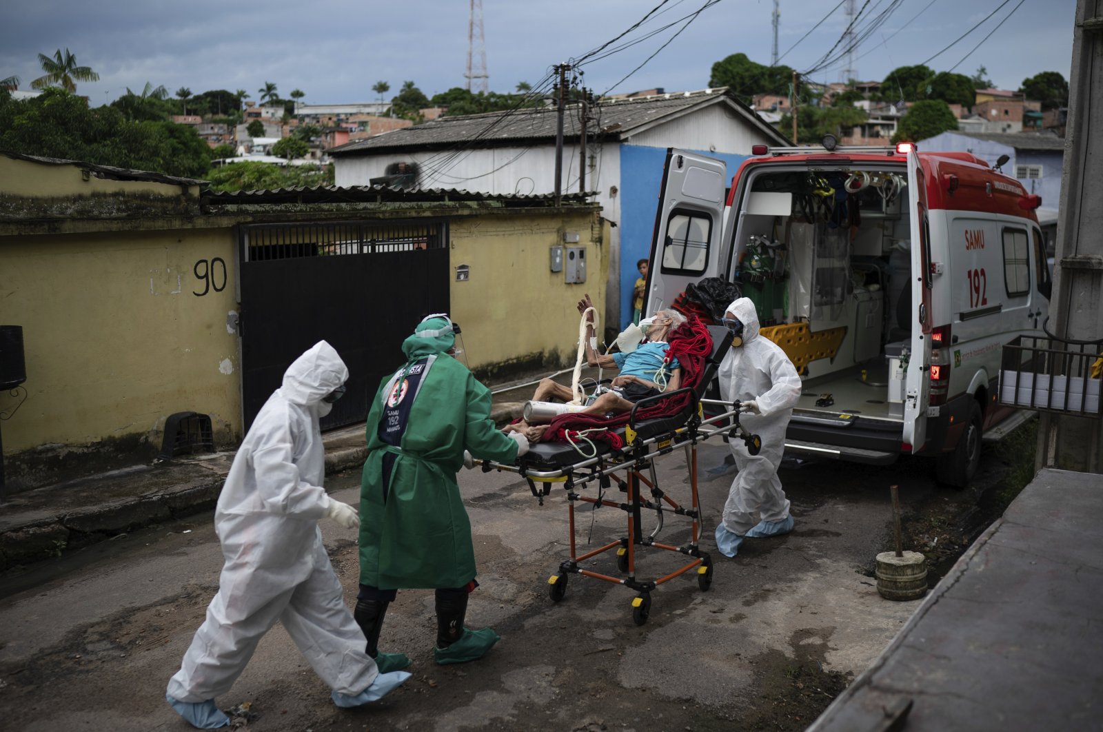 Emergency workers transfer an elderly patient, suspected of having COVID-19, to a hospital in Manaus, Brazil, Wednesday, May 13, 2020. (AP Photo)