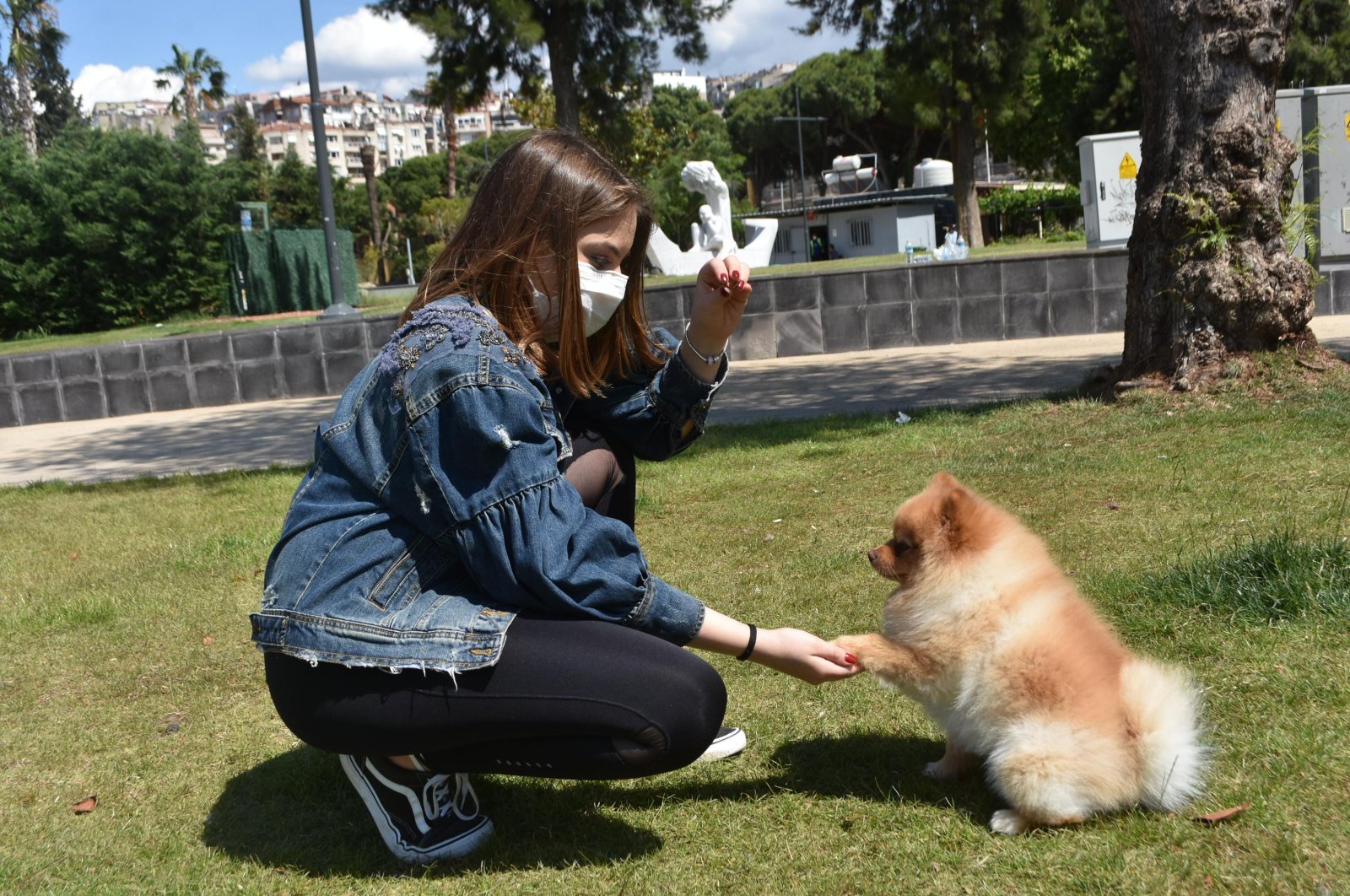 A woman plays with her dog in a park, Izmir, June 1, 2020. (DHA Photo)