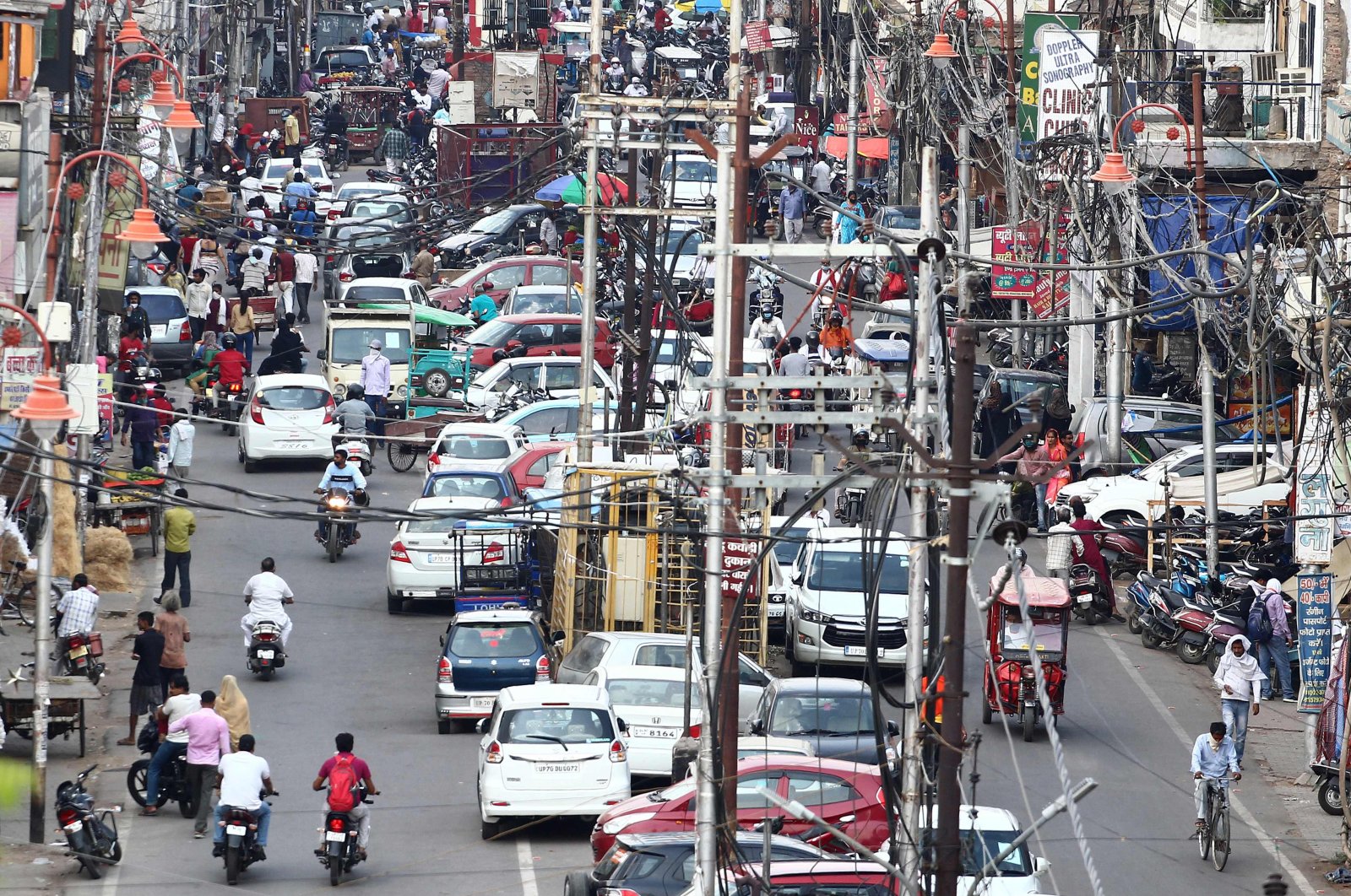 Commuters are seen along a road in the old City Chowk area after the government eased restrictions imposed as a preventive measure against the COVID-19 coronavirus, Allahabad, June 1, 2020. (AFP Photo)