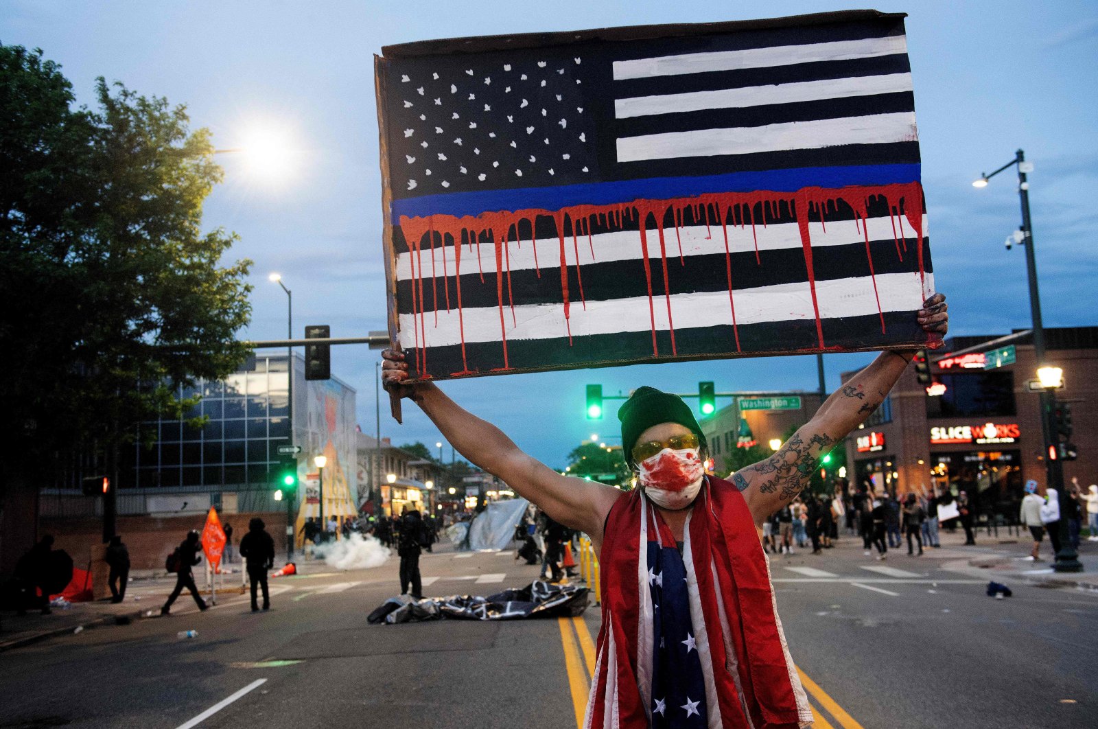 A demonstrator holds up a sign during a protest, Denver, May 31, 2020. (AFP Photo)