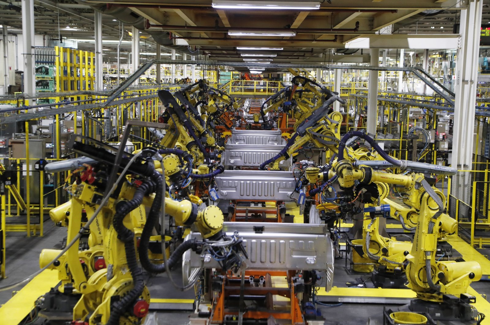 Robots weld the bed of a 2018 Ford F-150 truck on the assembly line at the Ford Rouge assembly plant in Dearborn, Michigan, U.S., Sept. 27, 2018. (AP Photo)