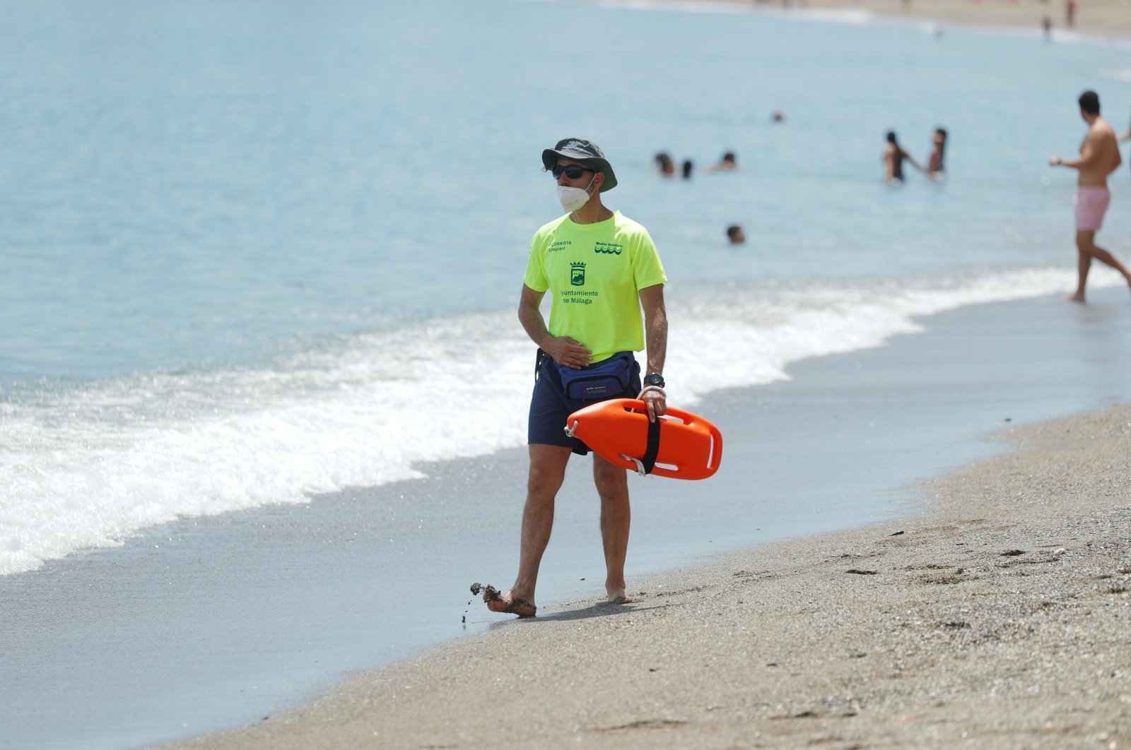 A lifeguard wears a protective face mask as he keeps watch at the shore on La Malagueta beach, Malaga, southern Spain, June 1, 2020. (Reuters Photo)