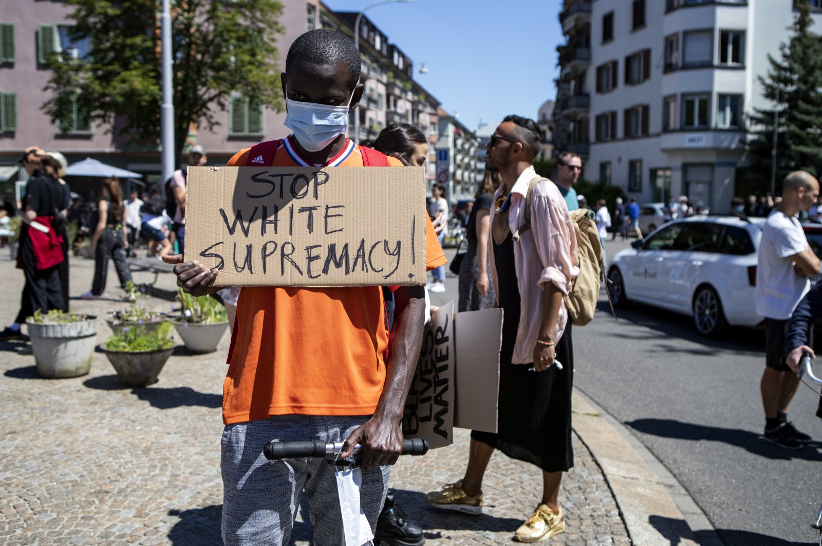 An activist wearing a face mask holds up a placard reading in English, "Stop White Supremacy!" as he takes part in a Black Lives Matter protest against the recent death of George Floyd, in Zurich, Switzerland, June 1, 2020. (EPA Photo)