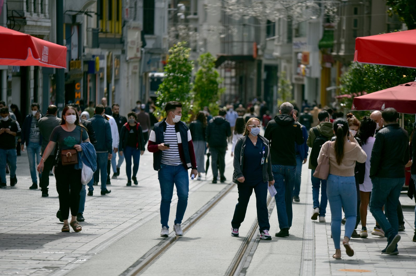 People walk on Istiklal Avenue as restrictions to stem the spread of the coronavirus are lifted across the country, Istanbul, Turkey, June 1, 2020. (DHA Photo)