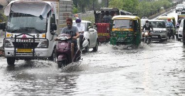 Commuters make their way through a water-logged street after heavy rainfall in Amritsar, Punjab, India, June 2, 2020. (AFP Photo)