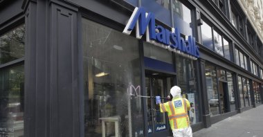A worker with San Francisco Public Works sprays graffitti off the window of a Marshalls store in San Francisco, California, U.S., May 31, 2020, after protests over the Memorial Day death of George Floyd. (AP Photo)