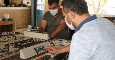 Customers play okey on their cellphones in Adıyaman, Turkey, June 2, 2020. (DHA Photo) 