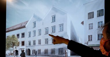 A man points his finger at a screen showing the chosen plan for the architectural redesign of Adolf Hitler's birth house, during a press conference at the Interior ministry in Vienna, Austria on June 2, 2020. (AFP Photo)