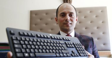 Celal Aşkın, a Justice Ministry employee, became world champion in the senior category by entering 153 words in a minute.(AA Photo)