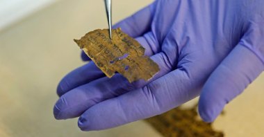 A conservator of the Israeli Antiquities Authority shows fragments of the Dead Sea Scrolls at their laboratory in Jerusalem, Israel, June 2, 2020. (AFP Photo)