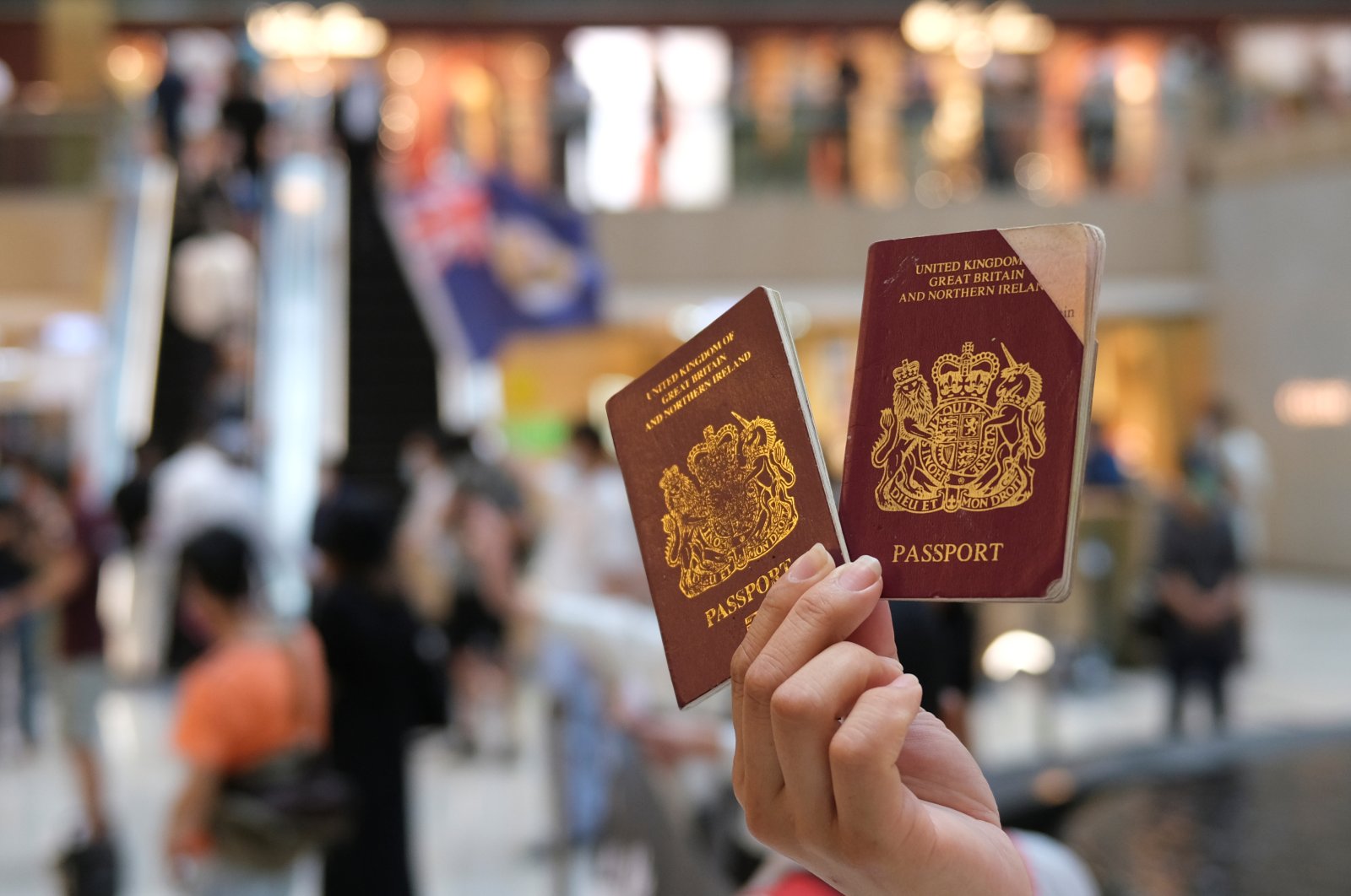 A pro-democracy demonstrator raises his British National Overseas (BNO) passports during a protest against new national security legislation in Hong Kong, China June 1, 2020. (Reuters Photo)