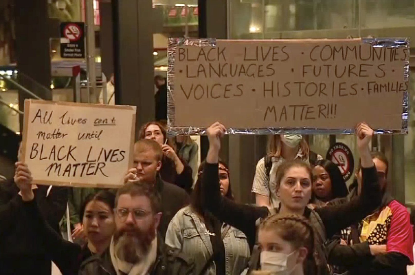 Protesters hold up placards reading "Black Lives Matter" during a peaceful rally in Perth, Australia, Monday, June 1, 2020. (Channel 10 via AP)