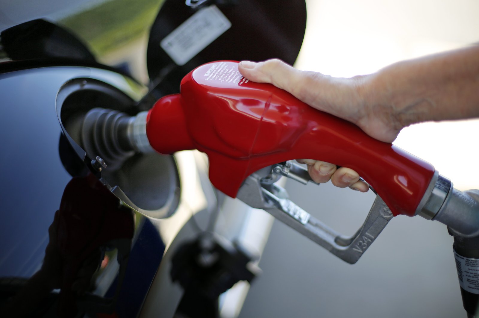 A woman fills her car with gasoline at a Costco gas station in Robinson Township, Pennsylvania, U.S., July 16, 2015. (AP Photo)