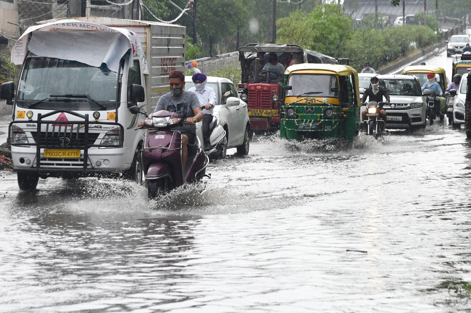 Commuters make their way through a water-logged street after heavy rainfall in Amritsar, Punjab, India, June 2, 2020. (AFP Photo)