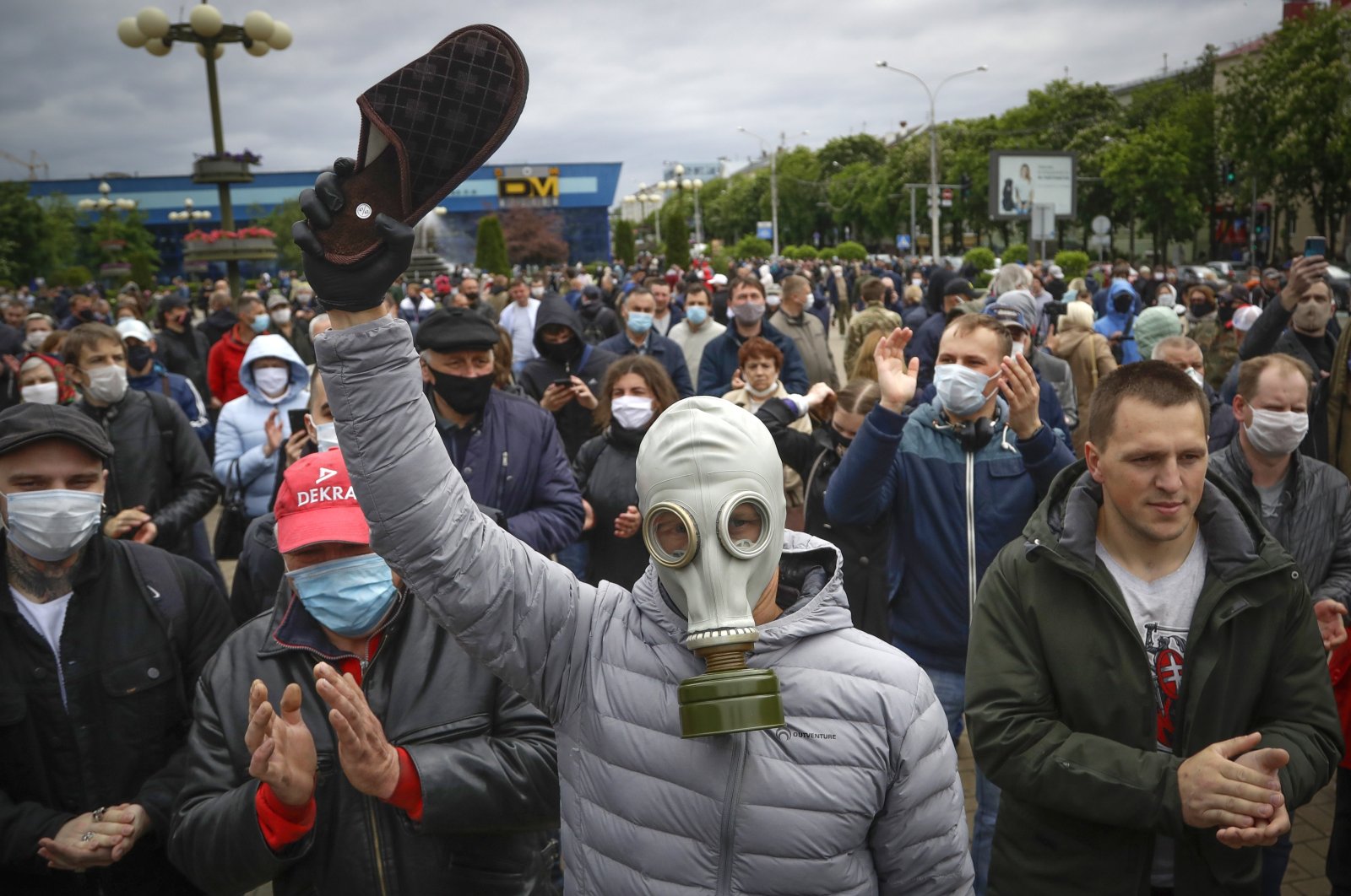 A man, wearing a gas mask to protect against the coronavirus, attends a rally to support for potential presidential candidates in the upcoming presidential elections in Minsk, Belarus, Sunday, May 31, 2020. (AP Photo)
