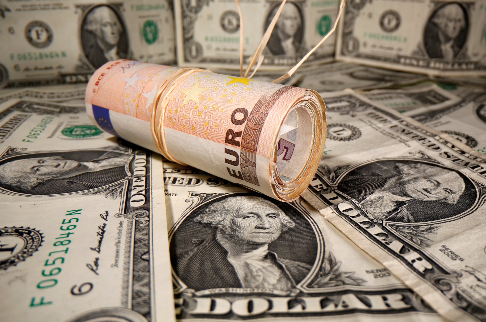 Rolled Euro banknotes are placed on U.S. Dollar banknotes in this illustration taken May 26, 2020. (Reuters Photo)