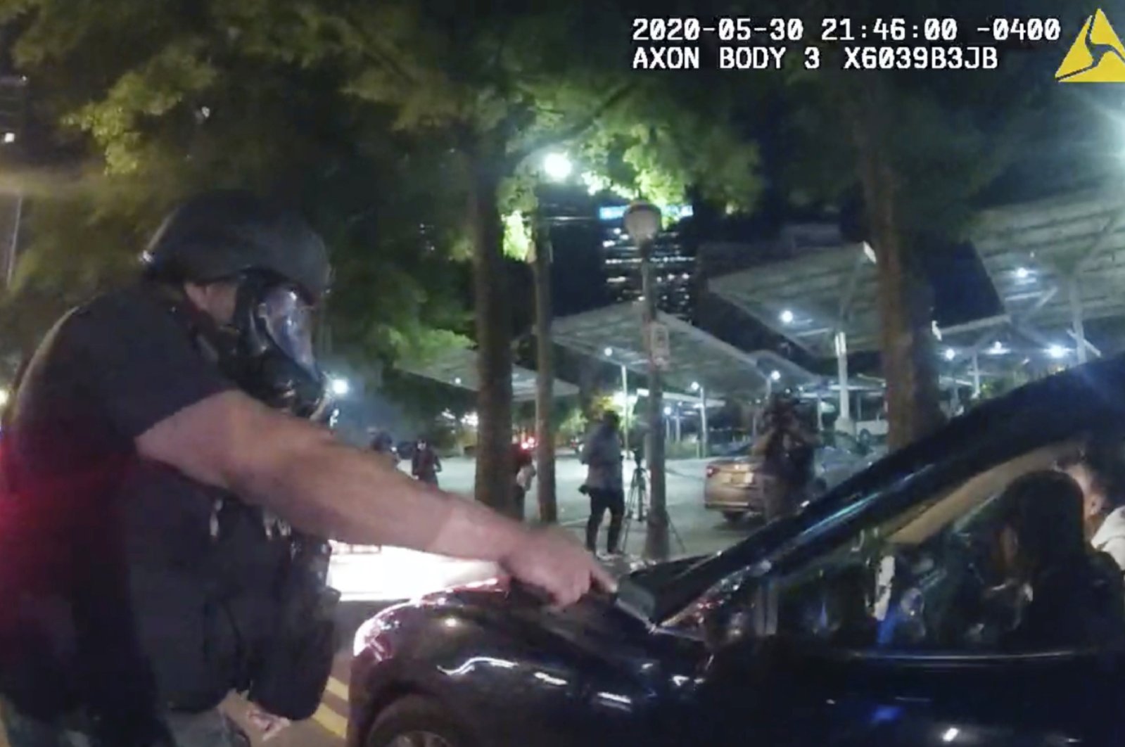 In this photo taken from police body camera video released by the Atlanta Police Department, an officer points his handgun at Messiah Young while the college student is seated in his vehicle, in Atlanta, Georgia, May 30, 2020. (AP Photo)