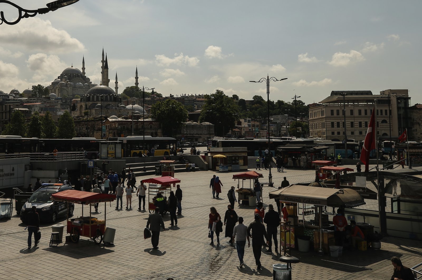 People walk in Istanbul, as shops reopen following weeks of closures due to the coronavirus pandemic, June 1, 2020. (AP Photo)