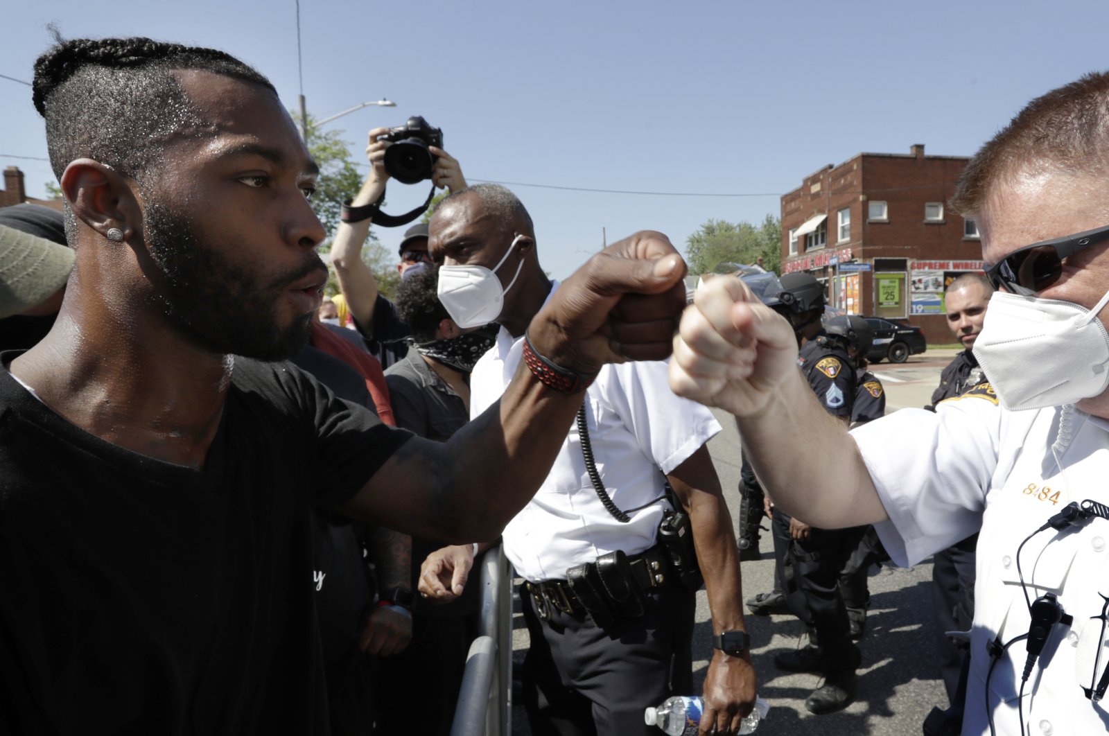 Cleveland Police First District Commander Daniel Fay, right, and a protester give each other a fist bump during a rally for black lives, in Cleveland, Ohio, June 2, 2020. (AP Photo)