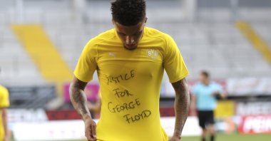 Borussia Dortmund's Jadon Sancho celebrates a goal with a "Justice for George Floyd" shirt during a Bundesliga match in Paderborn, Germany, May 31, 2020. (AP Photo)