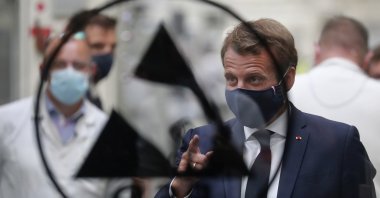 French President Emmanuel Macron wears a face mask during his visit to Valeo's manufacturing plant, in Etaples, northern France, May 26, 2020. (AP Photo)