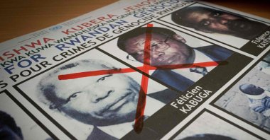 A photo shows a red cross drawn on the face of Felicien Kabuga, one of the last key suspects in the 1994 Rwandan genocide, on a wanted poster at the Genocide Fugitive Tracking Unit office in Kigali, Rwanda, May 19, 2020. (AFP Photo)
