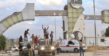 Pro-government forces pose in front of the entrance of the Libya International Airport in Tripoli on Wednesday, June 3, 2020 (AA Photo)