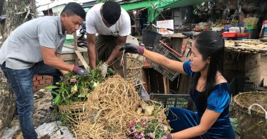 Inda Aung Soe (L) and his wife Aye Aye Than collect food waste at the wet market to produce organic fertilizer, Yangon, Myanmar, June 3, 2020. (Reuters Photo)