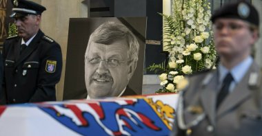 In this file photo a picture of Walter Luebcke stands behind his coffin during the funeral service in Kassel, Germany, June 13, 2019. (AP Photo)