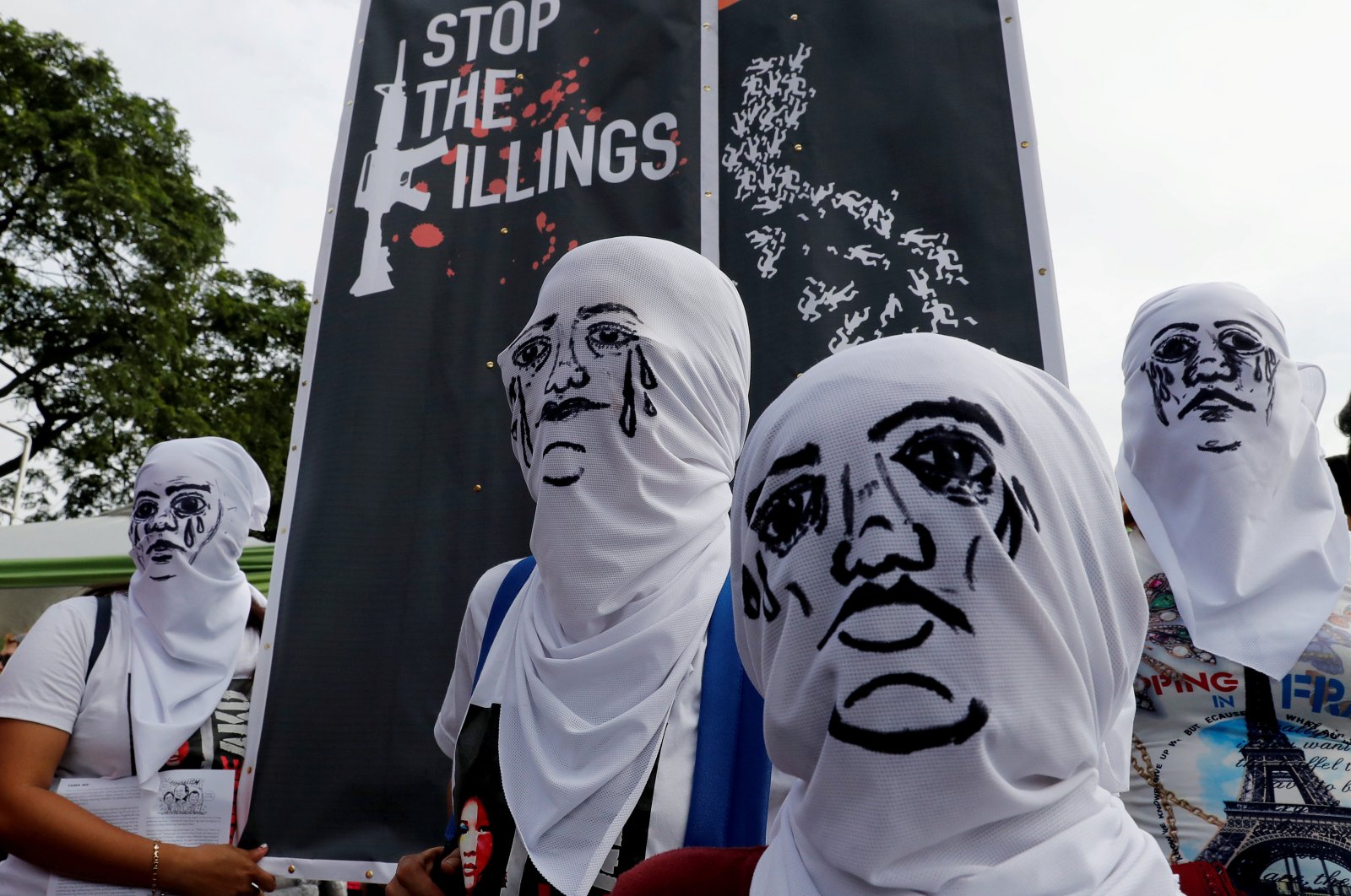 Activists wear hoods depicting families of victims killed in President Rodrigo Duterte's drug war as Duterte delivers his State of the Nation address in Quezon City, Metro Manila, Philippines, July 23, 2018. (Reuters Photo)