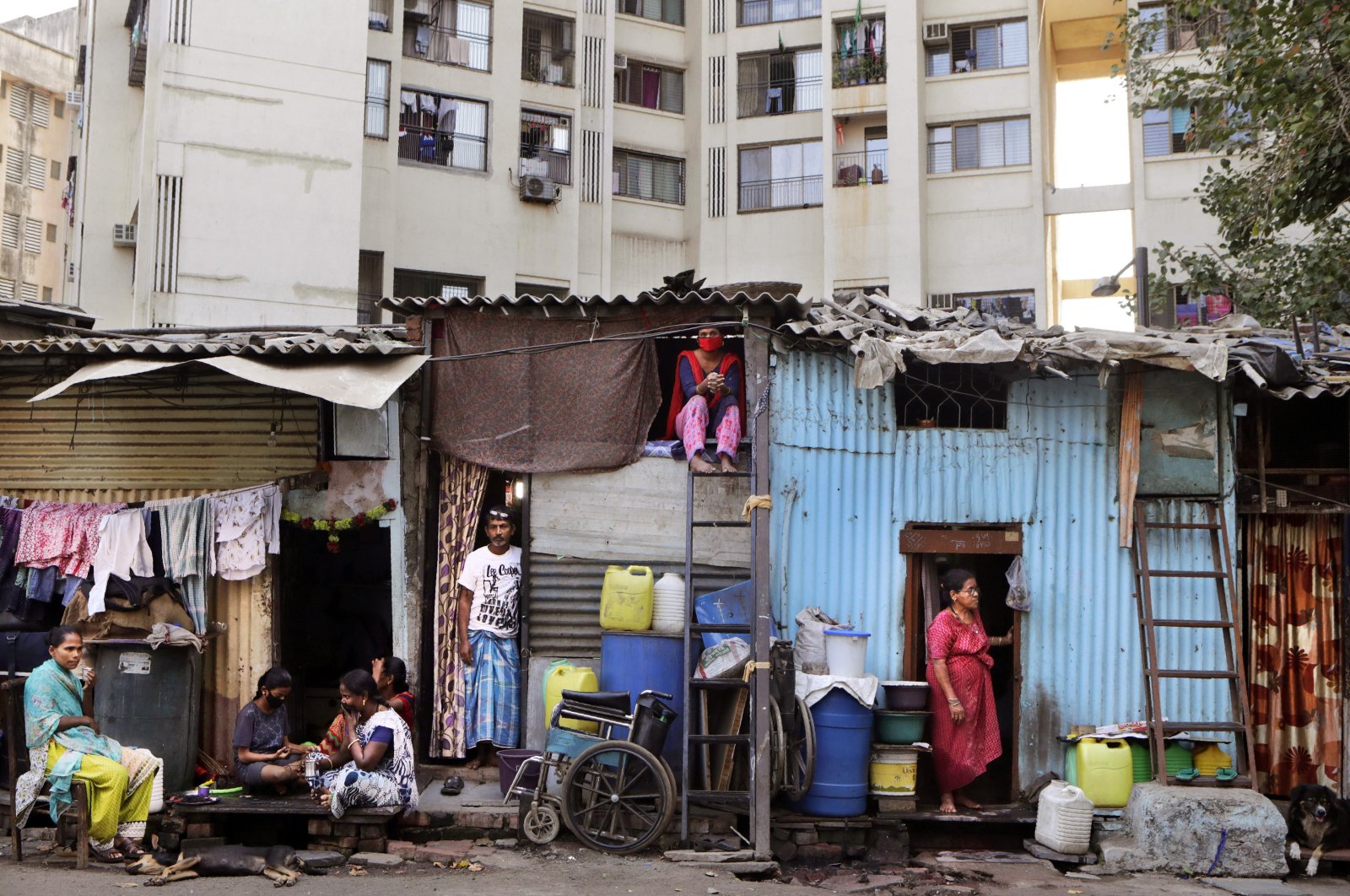 People rest by their shanties at Dharavi, one of Asia's largest slums, during lockdown to prevent the spread of the coronavirus, Mumbai, India, April 3, 2020. (AP Photo)