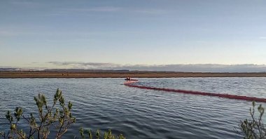 This handout photograph released by the Marine Rescue Service of Russia on June 4, 2020, shows a temporary floating barrier near a large diesel spill in the Ambarnaya River outside Norilsk. (Marine Rescue Service of Russia via AFP)