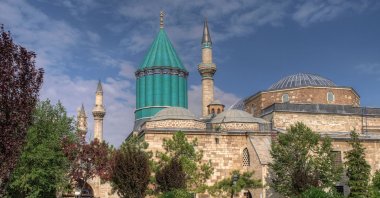 The shrine of Rumi in central Konya province comes to the forefront with its distinctive green-tiled cylindrical dome.