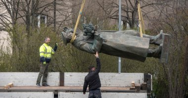 Workers load the statue of Soviet general and Marshal of the Soviet Union Ivan Stepanovic Konev on a truck as it is made ready for removal in Prague, April 3, 2020. (AFP Photo)