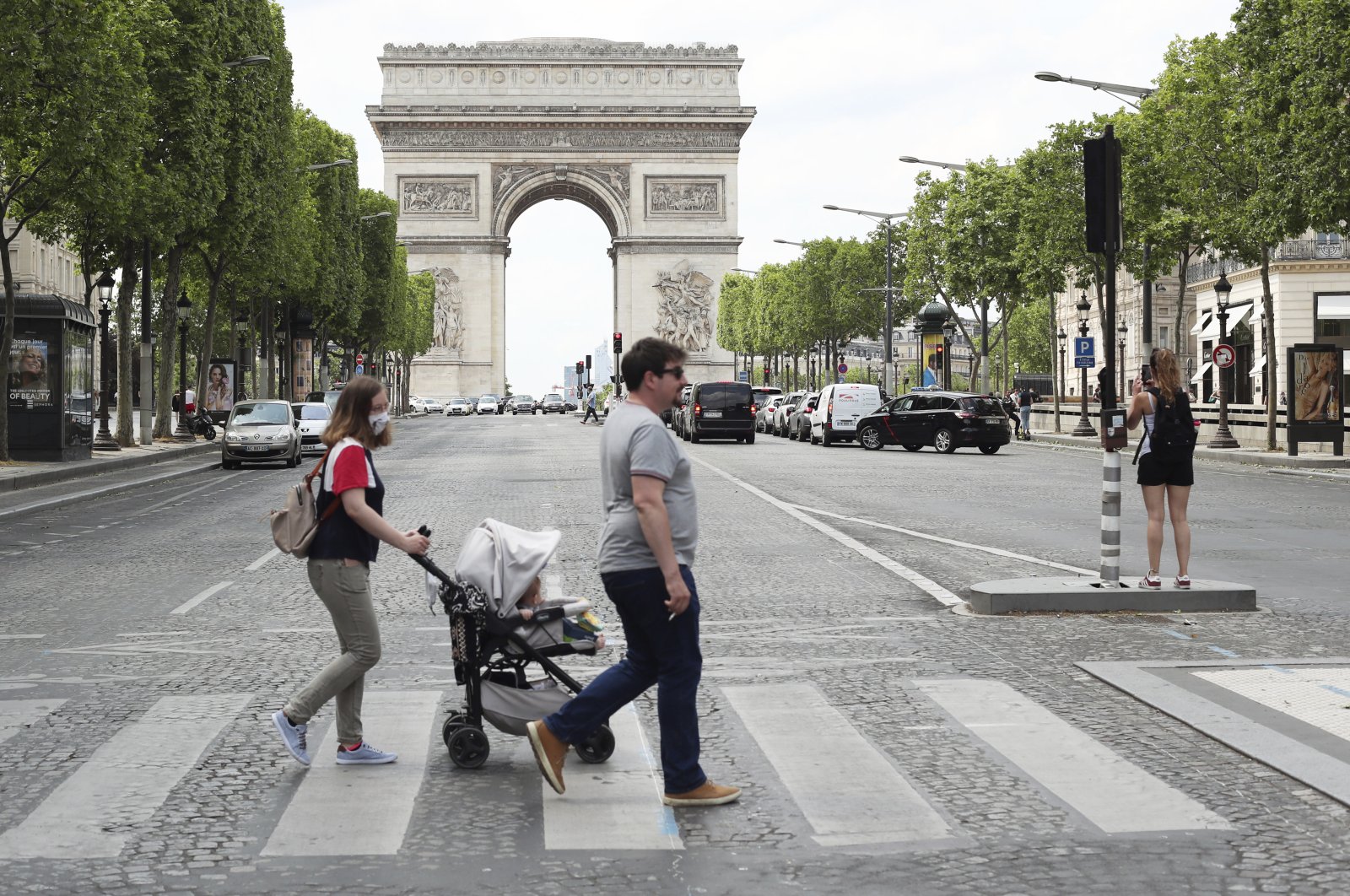 People stroll on the Champs Elysees avenue in Paris, France, June 3, 2020. (AP Photo)