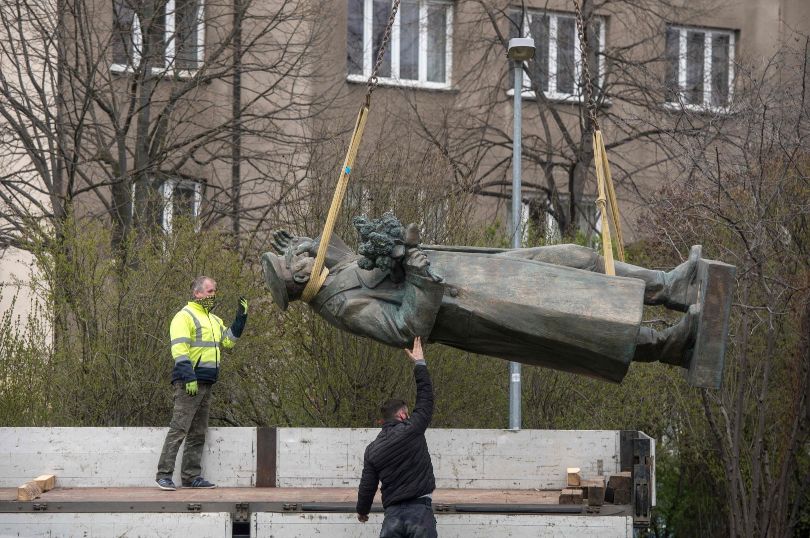 Workers load the statue of Soviet general and Marshal of the Soviet Union Ivan Stepanovic Konev on a truck as it is made ready for removal in Prague, April 3, 2020. (AFP Photo)