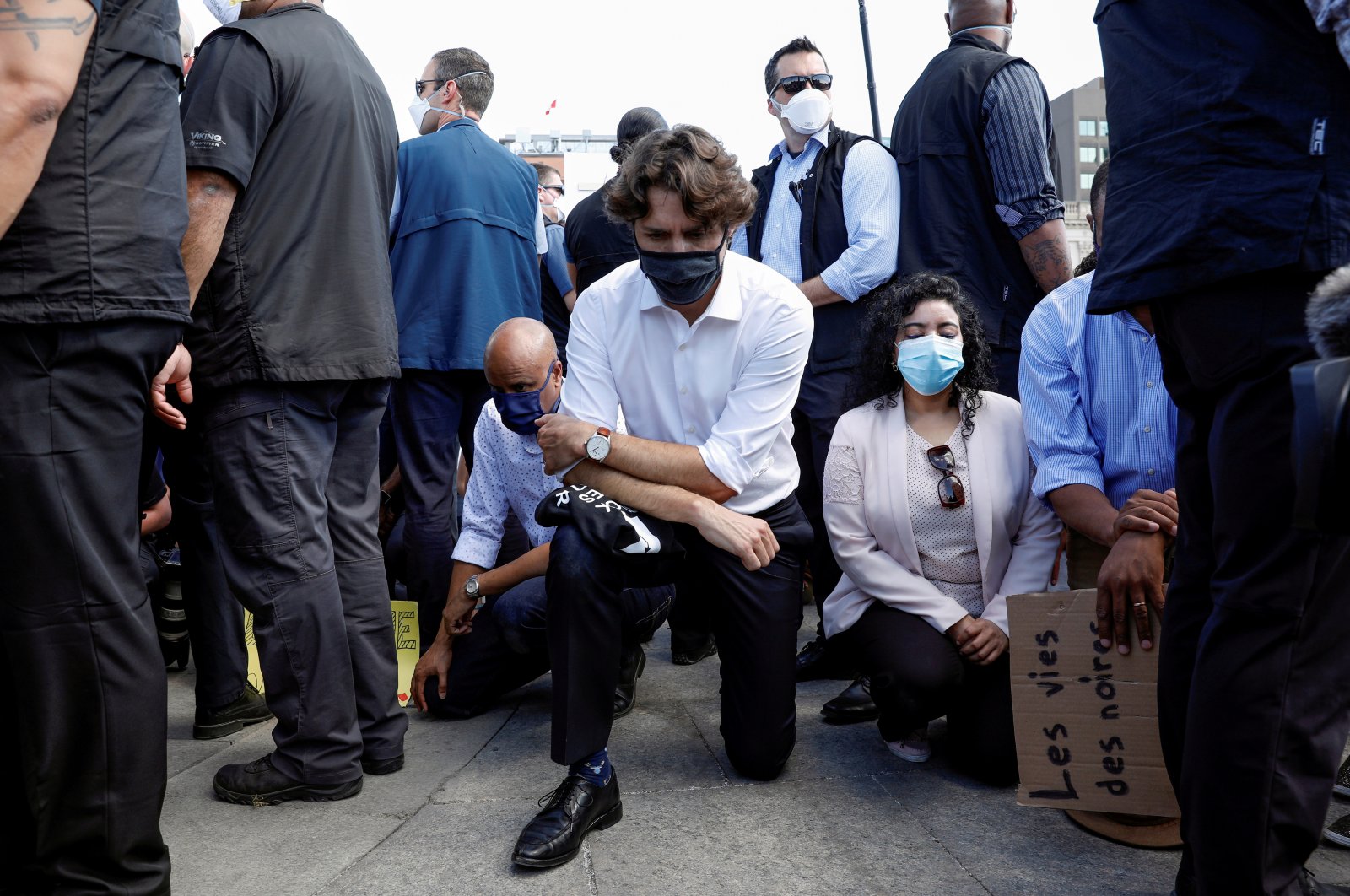 Canada's Prime Minister Justin Trudeau wears a mask as he takes a knee during a rally against the death in Minneapolis police custody of George Floyd, on Parliament Hill, in Ottawa, Ontario, Canada June 5, 2020. (Reuters Photo)