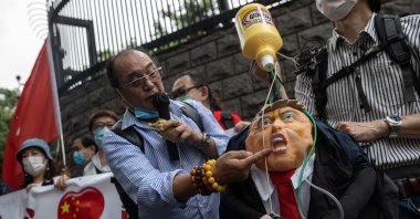 Protesters display banners and a doll of Donald Trump hooked up to a bottle of bleach during a rally outside the U.S. Consulate General in Hong Kong, China, May 30, 2020. (EPA Photo)